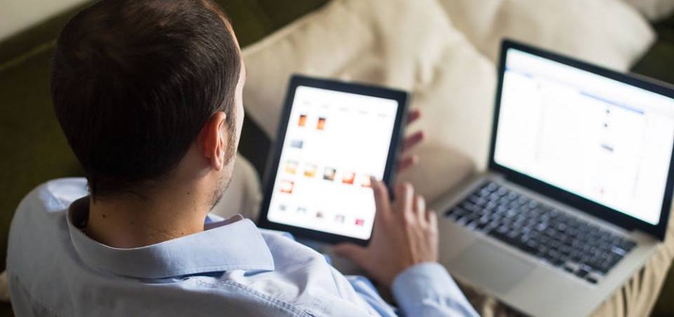 A picture of a man looking at the screen of his mobile device